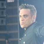 No, Robbie Williams isn't dressing up as Robert Plant to taunt Jimmy Page